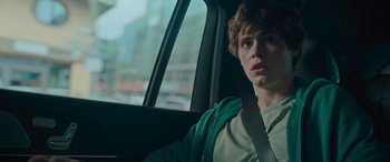 Movie still from “Retribution” (2023), directed by Nimród Antal – A man sitting in the back seat of a car; Close Up shot, Low angle