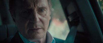 Movie still from “Retribution” (2023), directed by Nimród Antal – An older man with a serious look on his face in a car; Close Up shot, Over the shoulder angle