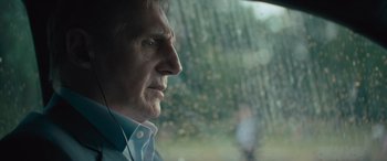 Movie still from “Retribution” (2023), directed by Nimród Antal – An older man looking out of a car window; Close Up shot, Over the shoulder angle