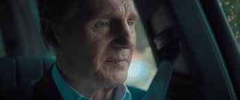 Movie still from “Retribution” (2023), directed by Nimród Antal – An older man sitting in a car looking out the window; Close Up shot, Over the shoulder angle