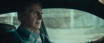 Movie still from “Retribution” (2023), directed by Nimród Antal – An older man sitting in the driver's seat of a car; Close Up shot, Over the shoulder angle
