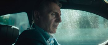 Movie still from “Retribution” (2023), directed by Nimród Antal – A person sitting in a car looking out the window; Close Up shot, Over the shoulder angle
