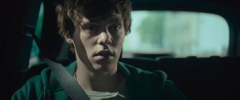 Movie still from “Retribution” (2023), directed by Nimród Antal – A man sitting in the back seat of a car; Close Up shot, Over the shoulder angle