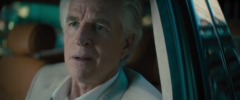 Movie still from “Retribution” (2023), directed by Nimród Antal – An older man in a white shirt looking out a window; Close Up shot, Over the shoulder angle