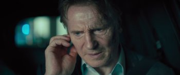 Movie still from “Retribution” (2023), directed by Nimród Antal – A person holding his hand up to his ear; Close Up shot, Low angle