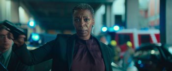 Movie still from “Retribution” (2023), directed by Nimród Antal – An older black woman wearing a purple shirt and a black jacket; Close Up shot, Low angle