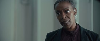 Movie still from “Retribution” (2023), directed by Nimród Antal – An older black woman with short grey hair looking at the camera; Close Up shot, Over the shoulder angle