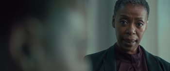 Movie still from “Retribution” (2023), directed by Nimród Antal – A person wearing a suit and tie; Close Up shot, Over the shoulder angle