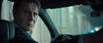 Movie still from “Retribution” (2023), directed by Nimród Antal – A person sitting in a car; Close Up shot, Low angle