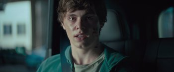 Movie still from “Retribution” (2023), directed by Nimród Antal – A young man is sitting in the back of a car; Close Up shot, Over the shoulder angle