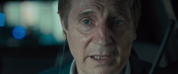 Movie still from “Retribution” (2023), directed by Nimród Antal – An older man with blue eyes looking at the camera; Close Up shot, Over the shoulder angle