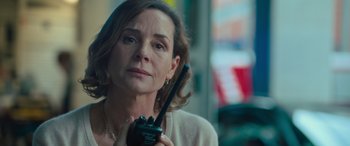 Movie still from “Retribution” (2023), directed by Nimród Antal – A person holding a walkie talkie; Close Up shot, Over the shoulder angle