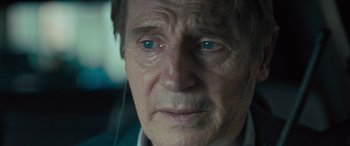 Movie still from “Retribution” (2023), directed by Nimród Antal – An older man with blue eyes stares into the camera; Close Up shot, Over the shoulder angle