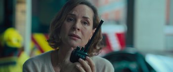 Movie still from “Retribution” (2023), directed by Nimród Antal – A person holding a walkie talkie; Close Up shot, Low angle