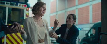 Movie still from “Retribution” (2023), directed by Nimród Antal – A woman in a white dress and a man in a blue jacket; Medium shot, Over the shoulder angle