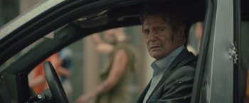 Movie still from “Retribution” (2023), directed by Nimród Antal – A person sitting in a car; Close Up shot, Over the shoulder angle