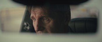 Movie still from “Retribution” (2023), directed by Nimród Antal – A person's face with a blurry background; Close Up shot, Over the shoulder angle