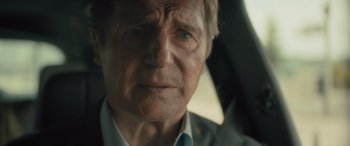 Movie still from “Retribution” (2023), directed by Nimród Antal – An older man with a blue tie in a car; Close Up shot, Over the shoulder angle
