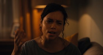 Movie still from “Barbarian” (2022), directed by Zach Cregger – A young woman is crying in a dark room; Close Up shot, Over the shoulder angle