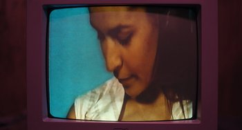 Movie still from “Barbarian” (2022), directed by Zach Cregger – A woman's face on a television screen; Extreme Close Up shot, High angle