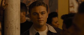 Movie still from “Revolutionary Road” (2008), directed by Sam Mendes – A person wearing a suit and tie; Close Up shot, Over the shoulder angle