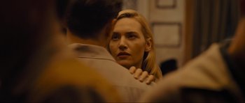 Movie still from “Revolutionary Road” (2008), directed by Sam Mendes – A person with their arms around another person; Close Up shot, Over the shoulder angle