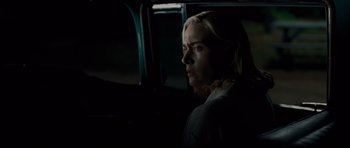 Movie still from “Revolutionary Road” (2008), directed by Sam Mendes – A woman sitting in a car looking out the window; Close Up shot, Over the shoulder angle