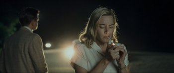 Movie still from “Revolutionary Road” (2008), directed by Sam Mendes – A woman holding a cigarette in her mouth; Close Up shot, Low angle