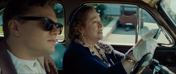Movie still from “Revolutionary Road” (2008), directed by Sam Mendes – An older woman sitting in the back seat of a car; Close Up shot, Over the shoulder angle