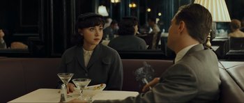 Movie still from “Revolutionary Road” (2008), directed by Sam Mendes – A woman sitting at a table in a restaurant; Medium shot, Over the shoulder angle