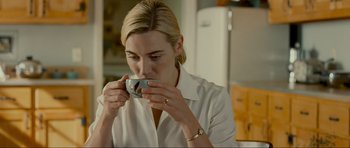 Movie still from “Revolutionary Road” (2008), directed by Sam Mendes – A woman is drinking a cup of coffee; Close Up shot, Over the shoulder angle