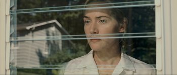 Movie still from “Revolutionary Road” (2008), directed by Sam Mendes – A person looking out a window; Close Up shot, Low angle