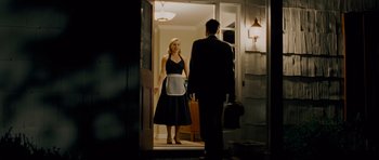 Movie still from “Revolutionary Road” (2008), directed by Sam Mendes – A man and a woman are standing in a doorway; Medium shot, Over the shoulder angle