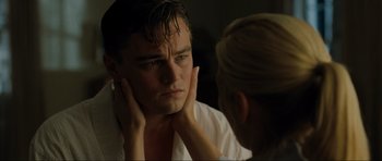 Movie still from “Revolutionary Road” (2008), directed by Sam Mendes – A woman touching the face of a young man in front of a mirror; Close Up shot, Over the shoulder angle
