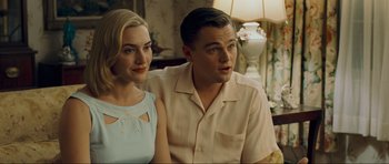 Movie still from “Revolutionary Road” (2008), directed by Sam Mendes – A man and a woman sitting next to each other in a room; Medium shot, Over the shoulder angle