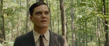 Movie still from “Revolutionary Road” (2008), directed by Sam Mendes – A person wearing a suit and tie; Close Up shot, Low angle