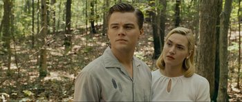 Movie still from “Revolutionary Road” (2008), directed by Sam Mendes – A man and a woman standing next to each other in the woods; Close Up shot, Low angle