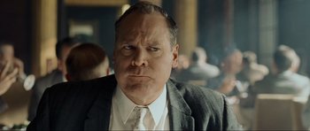 Movie still from “Revolutionary Road” (2008), directed by Sam Mendes – A man in a suit and tie looking angry; Close Up shot, Low angle