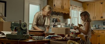 Movie still from “Revolutionary Road” (2008), directed by Sam Mendes – A woman in a kitchen preparing food on a table; Medium shot, Over the shoulder angle
