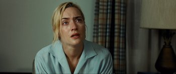 Movie still from “Revolutionary Road” (2008), directed by Sam Mendes – A person with her eyes wide open; Close Up shot, Over the shoulder angle