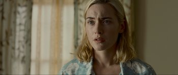 Movie still from “Revolutionary Road” (2008), directed by Sam Mendes – A person with long blonde hair; Close Up shot, Over the shoulder angle