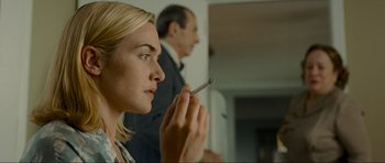 Movie still from “Revolutionary Road” (2008), directed by Sam Mendes – A woman is holding a cigarette in her hand; Close Up shot, Low angle