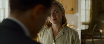 Movie still from “Revolutionary Road” (2008), directed by Sam Mendes – A woman in a white shirt looking at a man in a black shirt; Close Up shot, Over the shoulder angle