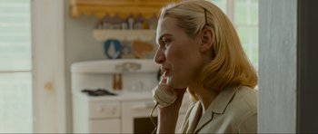 Movie still from “Revolutionary Road” (2008), directed by Sam Mendes – A woman talking on a phone in a kitchen; Close Up shot, Over the shoulder angle