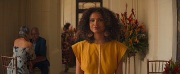 A woman in a yellow dress with long curly hair