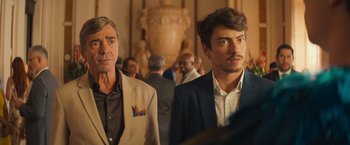 A man and a man standing next to each other in a room