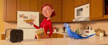 Movie still from “Rio” (2011), directed by Carlos Saldanha – An animated woman holding a box of cereal while a parrot stands next to her; Medium shot, Low angle