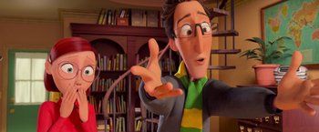 Movie still from “Rio” (2011), directed by Carlos Saldanha – A man and a woman in front of bookshelves; Medium shot, Over the shoulder angle