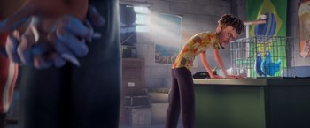 Movie still from “Rio” (2011), directed by Carlos Saldanha – A person in a room with a brick wall; Medium shot, Over the shoulder angle