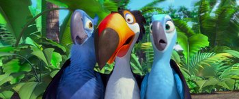 Movie still from “Rio” (2011), directed by Carlos Saldanha – A group of three parakeets standing next to each other in front of trees; Close Up shot, Low angle